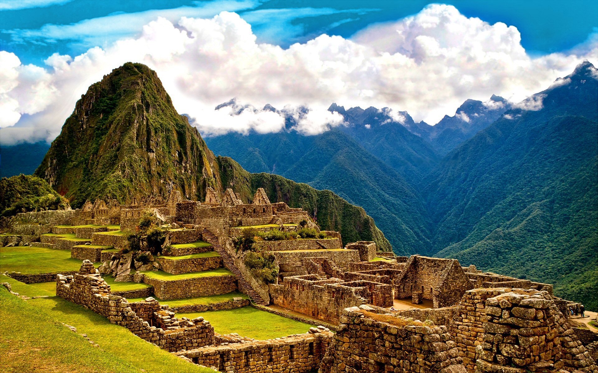 Machu Picchu is an ancient city that sits high up in the mountains, surrounded by gauzy wisps of cloud.